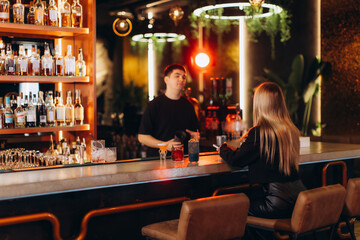 Elegant Bar Scene with a Bartender and Customer in a Stylish Setting