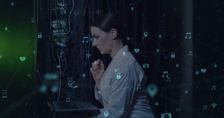 Image of media icons over caucasian female worker in server room
