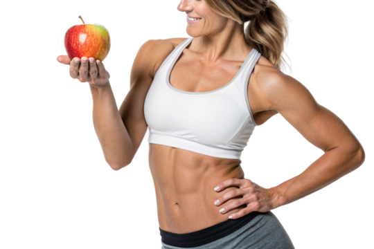 A fit woman in a white sports bra smiles while holding a bright red apple. The warm lighting highlights her toned body, promoting healthy lifestyle choices, isolated on a transparent background - Powered by Adobe