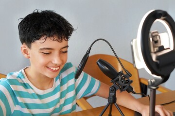 teenage boy recording a podcast with microphone and video. podcast, streamer concepts