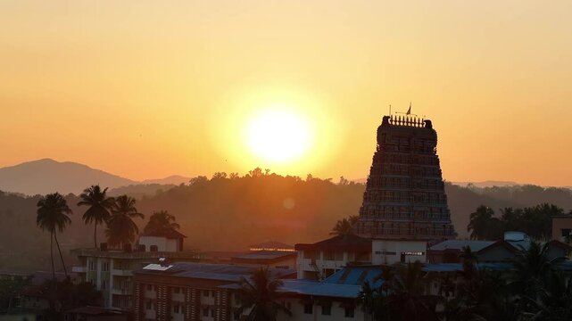 Aerial view of Sringeri Sharada Temple, located in the Chikkamagaluru district of Karnataka, India, alongside the serene Tunga River at sunset.
