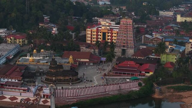 Aerial view of Sringeri Sharada Temple, located in the Chikkamagaluru district of Karnataka, India, alongside the serene Tunga River at sunset.