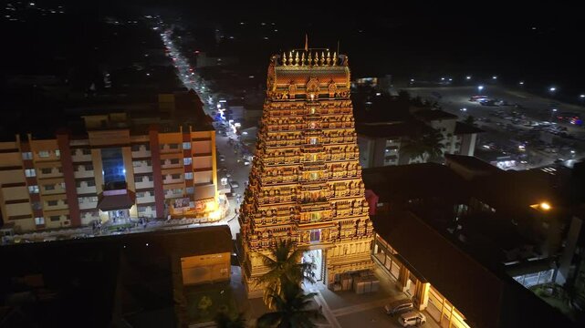 Aerial view of Sringeri Sharada Temple, located in the Chikkamagaluru district of Karnataka, India, alongside the serene Tunga River at sunset.