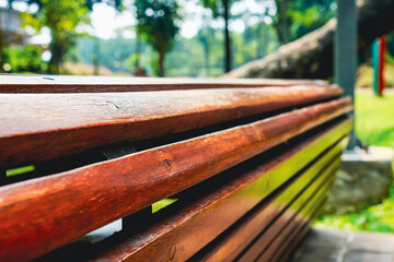Close-Up of Wooden Bench Slats in a Sunny Outdoor Park Setting