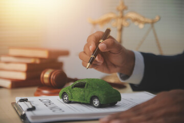 Judge gavel and miniature car symbolize auction or court case against driver who has accident and...