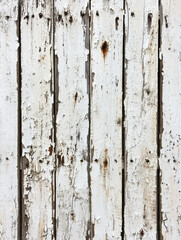 Obraz premium Weathered Timber Texture: Captivating view of a rustic, vertical wood plank backdrop, with peeling paint and a textured appearance, showcasing the effects of time and weather on the natural surface.