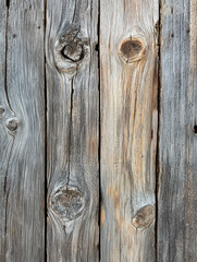 Naklejka premium Weathered Wood Texture: Close-up of aged, weathered wood grain with knots and imperfections, capturing the beauty of natural textures and patterns. 