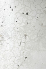 Fragment of a plastered wall with various surface defects that appeared over time vertical orientation