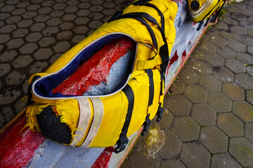 Close-Up of Worn Yellow Life Jacket on a Textured Surface