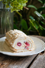 meringue roll with raspberry and almond petals