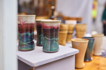 Handcrafted ceramic cups on display at an artisan market