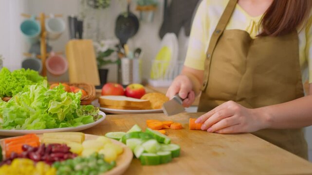Close up of woman cooking healthy foods in kitchen in morning at home. 
