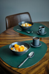 Cottage cheese with cream, banana and mango. Side view.