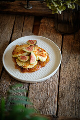 Syrniki with fig sauce and figs.	