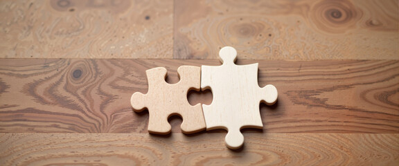 Single puzzle piece illustrates completeness on wooden table, symbolism
