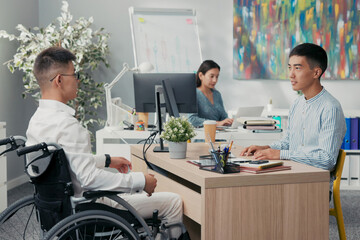 Two men meet in company office morning for interview disabled boy arrives in wheelchair wearing...