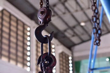 The load hangs on an old rusty iron hook, Crane Hook and Chain Link , Machine hook and chain