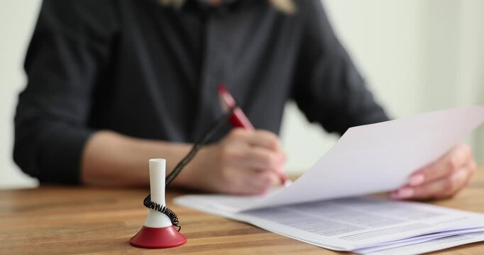 A person writing with a vibrant red pen on paper, demonstrating creativity and productivity in an organized way