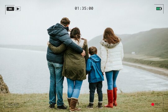 Parents with their children looking at the ocean