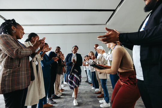 Professionals engaging in teambuilding event with collaborative activities and applause