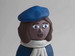 Plasticine Parisienne: French girl Insta avatar with brown clay hair in pastel tones, scarf and beret.
