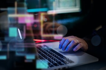 Man working on laptop in dark