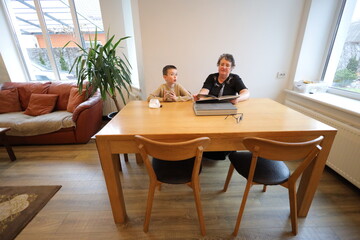 Grandmother and grandson talking indoors