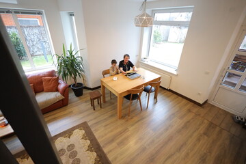 Grandmother and grandson talking indoors
