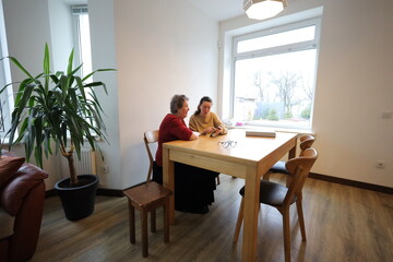 Woman showing grandmother how to use a phone  