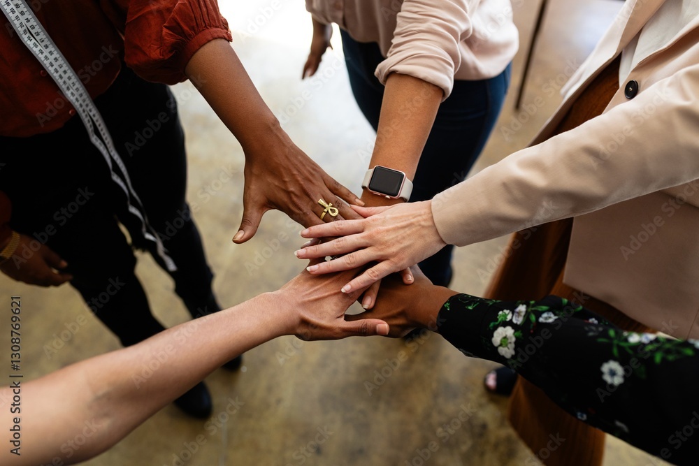 Poster diverse group of hands in a teamwork gesture. hands of different ethnicities joining together. unity