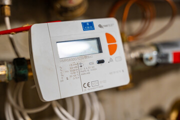 Smart water and heat meters with remote data transmission installed in a European utility system. The concept represents modern energy efficiency and digital infrastructure development