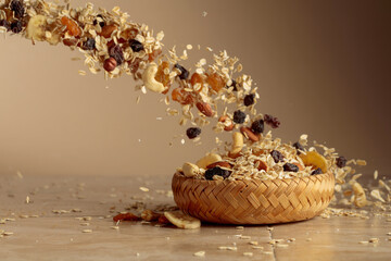 Muesli in motion on a beige background.