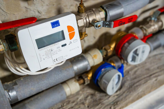 Smart water and heat meters with remote data transmission installed in a European utility system. The concept represents modern energy efficiency and digital infrastructure development