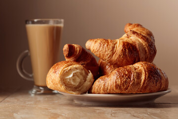 Freshly baked croissants and coffee with cream.