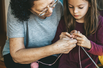 A traditional craft passed down through love - an elderly woman teaches her granddaughter how to...