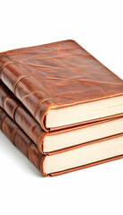 Obraz premium Stacked leather-bound notebooks, resting on a white surface, for writing, journaling, or education purposes
