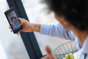 Man looking into phone camera while making selfie