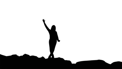 Silhouette of woman waving on rocky landscape