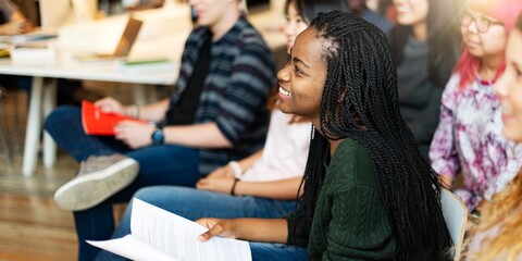 Diverse group of young students studying together in a classroom, smiling and engaged, Students collaborating. studying and focus to learn. Group of students in classroom. High school education.