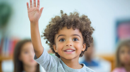 Joyful african child raises hand in classroom setting