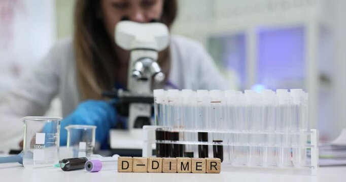 A dedicated scientist examines samples with a microscope, focusing on D Dimer test results for crucial data