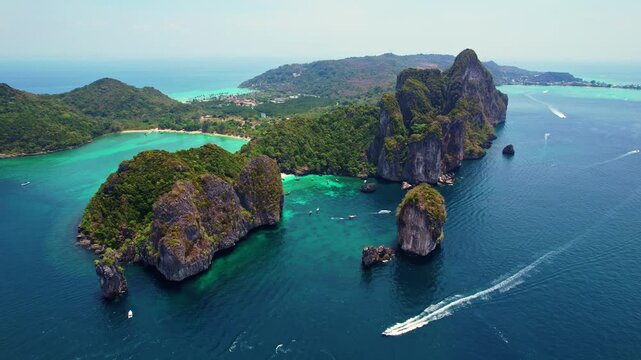 Turquoise lagoon with white coral sand Nui beach. Landscape koh Phi Phi Don island, Krabi, Thailand Aerial drone video.