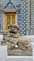 Sandstone doll at Wat Pho that is a Buddhist temple complex Chinese and Thai style in Bangkok,...