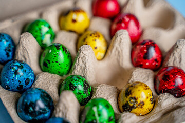 easter beautiful decorated orthodox religious quail eggs lie on egg carton on blue background with...