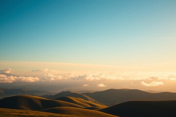 Serene View of Rolling Hills Under a Clear Sky with Distant Clouds