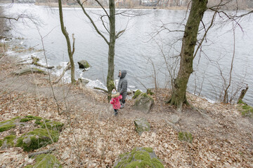 Mother and a child girl hiking in the forest