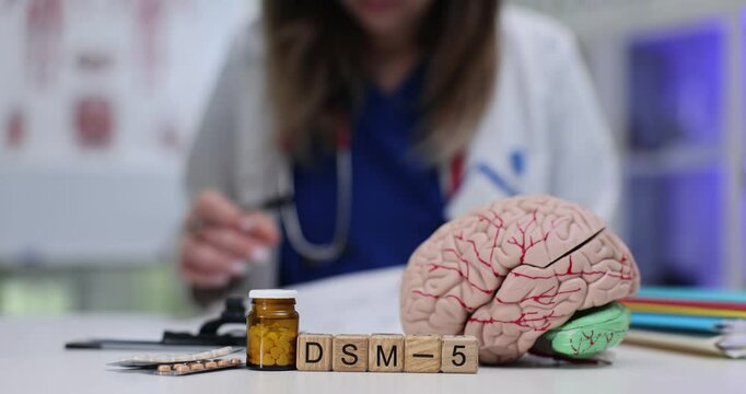 A visual representation of the DSM5 together with an illustration of the brain and various medical supplies