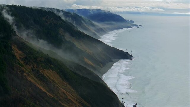 USAL Beach Sinkyone Wilderness Northern California aerial drone rugged untouched coastline mist rain evaporating morning remote untouched black sand waves crashing bluffs Lost Coast Trail forward pan