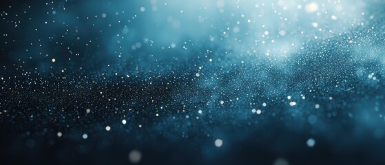 Fototapeta premium A mesmerizing display of blue particles shimmering against a dark background, creating a starry, ethereal atmosphere.