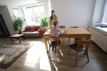 Mother and a daughter indoors spending time together